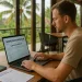 foreign remote worker in a Bali coworking space reviewing Indonesian immigration documents on a laptop, with a passport, visa forms, and tropical scenery in the background.